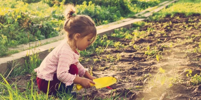 Child digging in garden